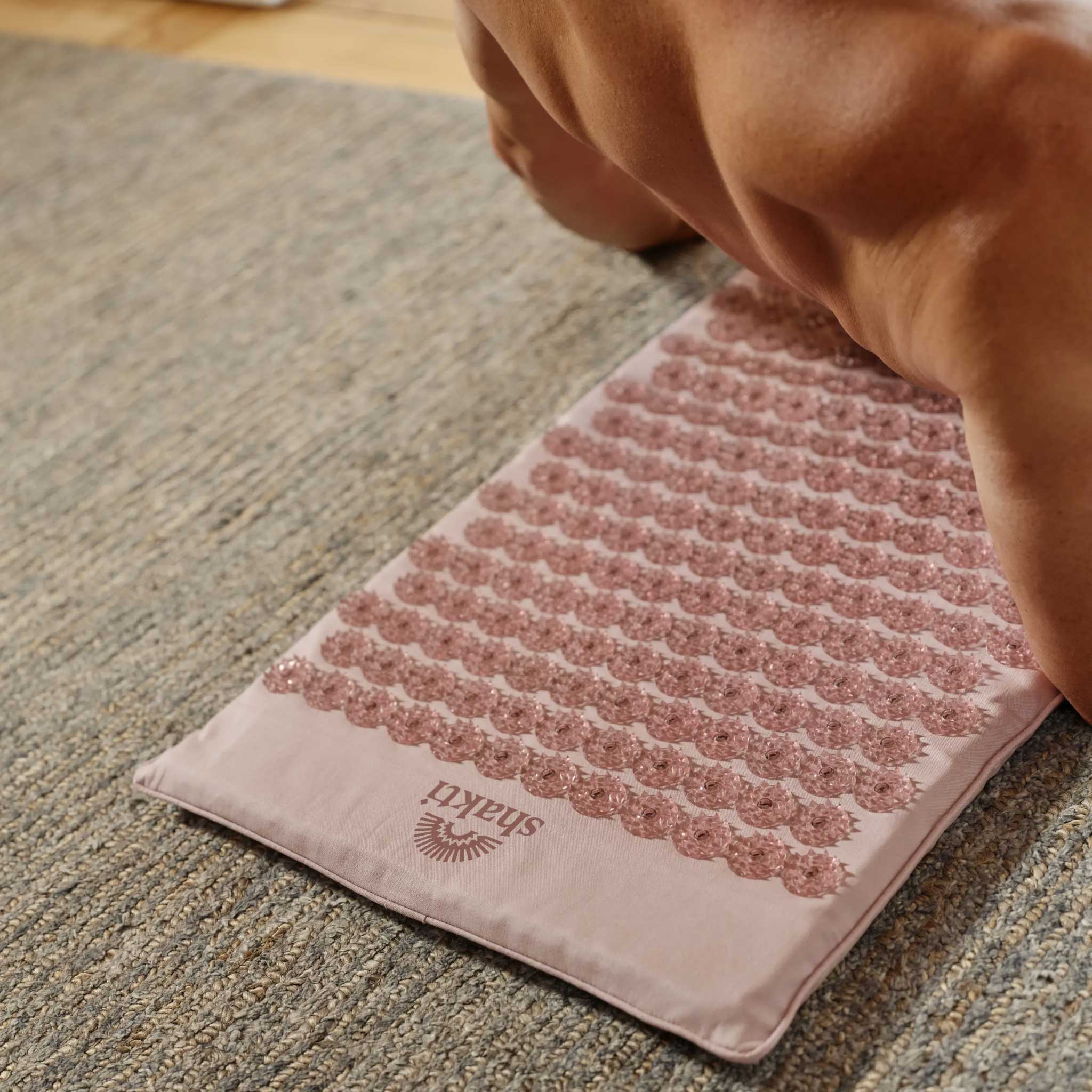 02_Shakti_Premium_Acupressure_Mat_Lifestyle_Rolling_Back_Pale_Petal_L2_813a2db0-2ea6-4142-a226-490d70667578.jpg
